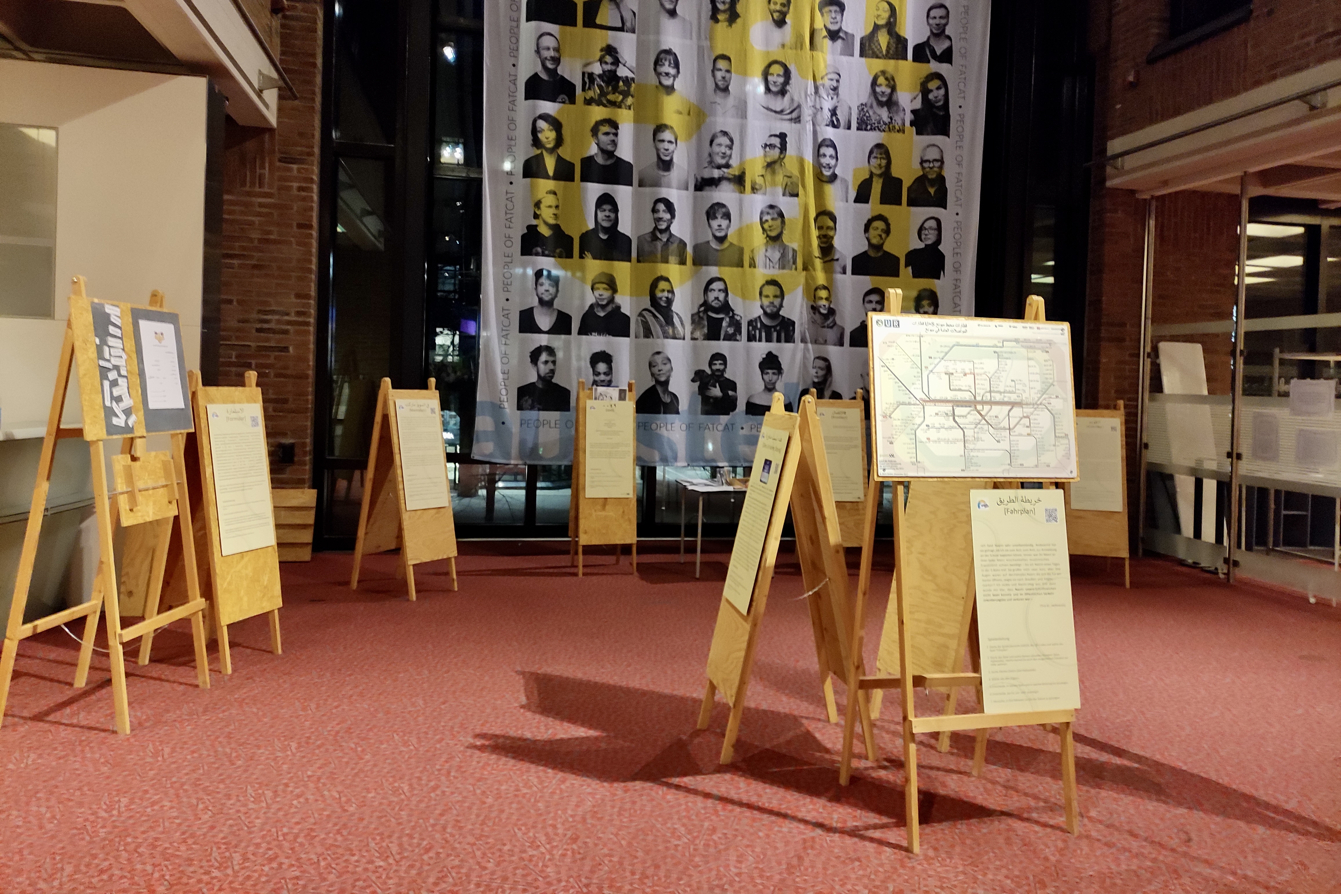 Ein Ausstellungsraum mit hohen Wänden. Ausstellungstafeln stehen im Raum.